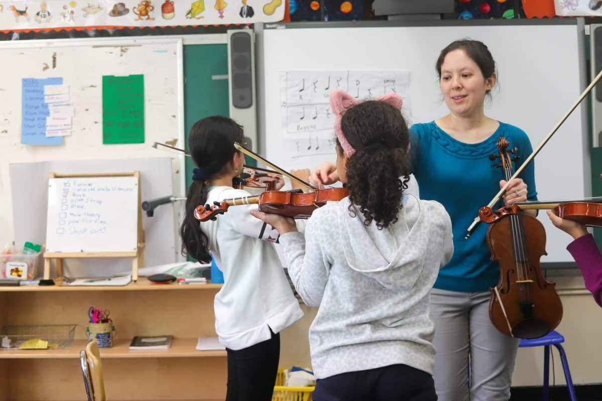 Evelyn Petcher teaches a violin class for the Bronx Arts Ensemble
